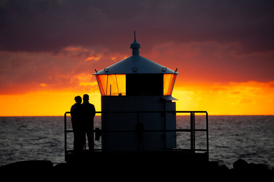 Kullen V&auml;stra Lighthouse in Sweden. A Couple is watching the beautiful sunset.