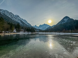 Scenic view of frozen lake Jezero Jasna in Kranjska Gora along road to Vrsic Pass in winter....