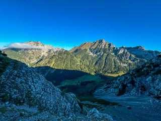 Obraz premium Scenic view of rugged mountain peak Wertatscha seen from Begunjscica, Loibl Pass in Karawanks, Slovenia Austria. Wanderlust in Austrian Slovenian Alps. Tranquil atmosphere in alpine wilderness. Hike