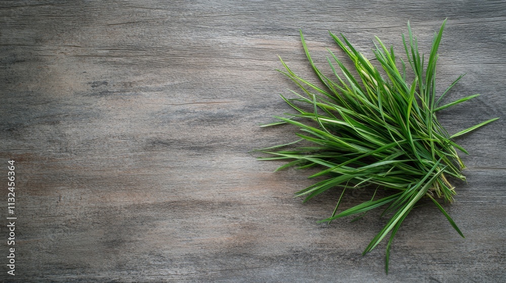 Poster Bright green grass is artfully arranged on a wooden background, showcasing a blend of natural elements and texture with ample empty space for additional content