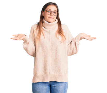 Beautiful caucasian woman wearing wool winter sweater clueless and confused expression with arms and hands raised. doubt concept.