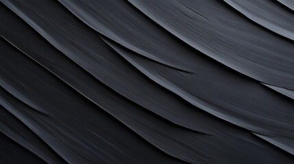 Obraz premium A single black tropical leaf showcases intricate veins, filling the frame. Soft lighting enhances its natural texture, creating a moody atmosphere with copy space