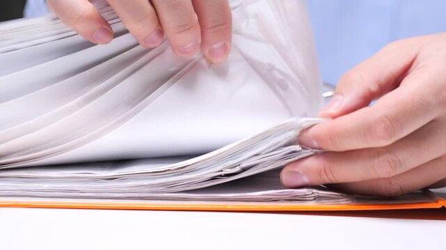 close-up Office worker searches for the necessary document in a folder