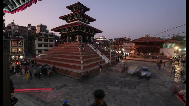 Kathmandu, Nepal: Time lapse of the sunset over the Durbar square with ancient newari temples in the historic Kathmandu city center. Shot with a zoom out motion