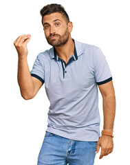 Handsome man with beard wearing casual clothes doing italian gesture with hand and fingers confident expression