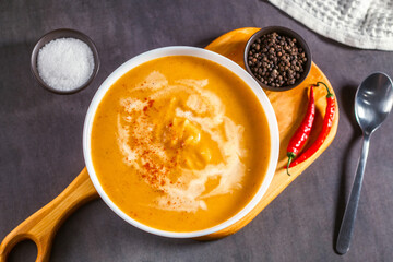 Pumpkin soup flat lay. Cream soup with paprika and chili pepper. Vegetable soup for vegan. Healthy eating. Concept of resaturant cafe healthy eating