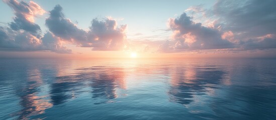 Obraz premium Serene sunset over calm ocean water with clouds reflecting.