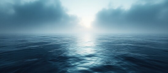 Obraz premium Serene ocean scene with misty sky and sunlit water.