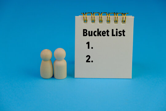Top view image of notebook with text BUCKET LIST on blue background with copy space.