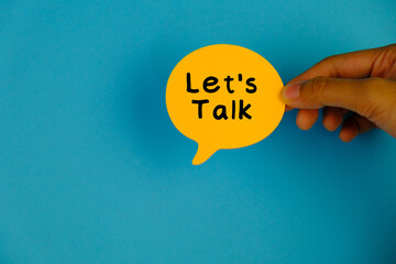 Top view image of speech bubble with text LET'S TALK on blue background with copy space. 