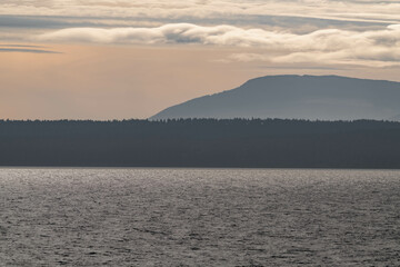 Fototapeta premium Vancouver island coastline during sunset, view from a ferry on the water