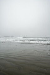 Chesterman beach all foggy on a moody, cloudy day. Near Tofino, Vancouver Island, British Columbia,...