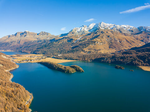 Aerial image of the Chaviolas, Islet on the lake of Silsersee in autumn color in St. Moritz, Switzerland