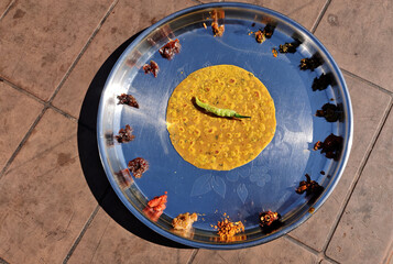 The image showcases a traditional Gujarati meal served on a steel plate, featuring a spiced flatbread (thepla) accompanied by assorted pickles and a chili chatni.