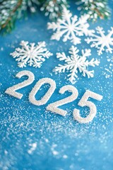 White snowflakes and 2025 on blue festive background.