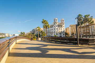 Beautiful street view of Ceuta with Hercules statue shade on the pavement in the foreground, Spain,...