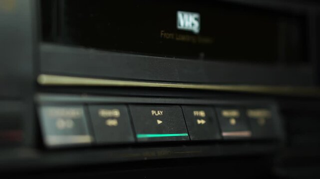 Loading Colored VHS Video Cassette Ta[e and Pressing Play Button on VCR