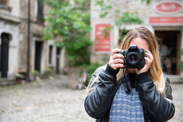 A female photographer takes pictures while visiting interesting tourist destinations