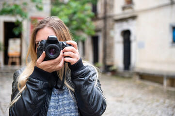 A female photographer takes pictures while visiting interesting tourist destinations