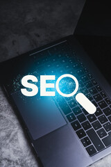 Search Engine Optimization concept. Laptop with SEO lettering. Use technology for search...