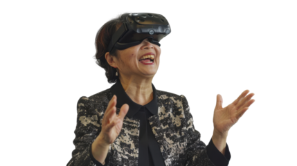 Asian caucasian senior businesswoman watching vr glasses laughing and gesturing with hand on white background

