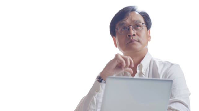 Asian middle age male Employee IT specialist sit at work with laptop on white background