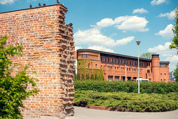 Fire station buildings near the old town ramparts in Poznań, Poland, showcasing historic red-brick...