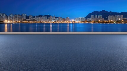 Fototapeta premium A highway winds through at night, with modern skyscrapers illuminated in blue lighting, creating a vibrant urban atmosphere