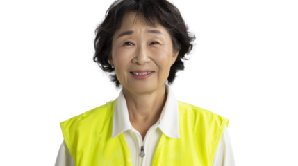 Asian senior female smiling in yellow warning vest safety on white background	

