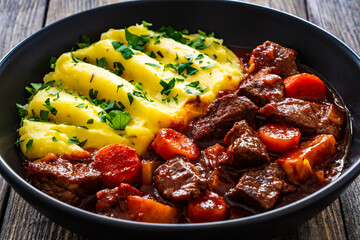 Irish stew for St. Patrick's Day - roast beef in beer with vegetables served with mashed potatoes...