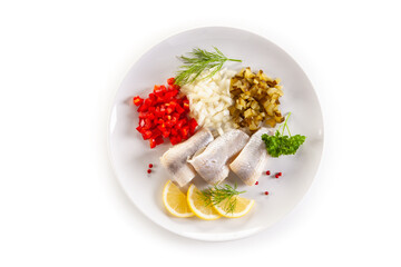 Marinated herring fillets with vegetables on white background