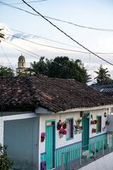 View Of A Traditional House With Colorful Windows And The Church Tower In Pijao, Colombia