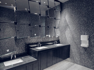 Public restrooms in the mall have hand washing counters and large mirrors. The interior is clean, bright, and luxurious decorated.