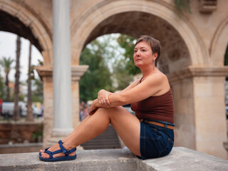 Woman walking narrow streets of old town Antalya during warm summer evening. Historic atmosphere...