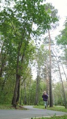Portrait of young sportswoman jogging during outdoor training in park in the morning. Sport and healthy lifestyle concept