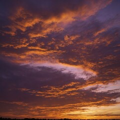 Fototapeta premium A golden sunset sky blending orange, pink, and purple hues.