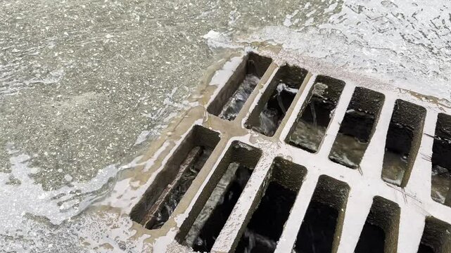 Rainwater flows into the sewer drain