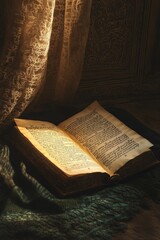 Antique book open, resting on fabric, illuminated.