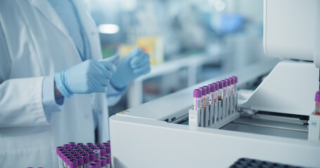 Close Up on Anonymous Female Scientist Working in a Sterile Environment in Modern Healthcare Facility. Skilled Laboratory Technician Operating Advanced Diagnostic Equipment, Processing Blood Samples