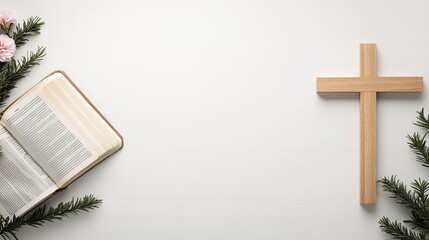 A top view of a Bible alongside a wooden cross and fresh pink flowers, set on a clean white table with soft, natural lighting