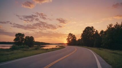 Winding Road Leading to Tranquil Lake with Stunning Sunset and Warm Sky Reflections

