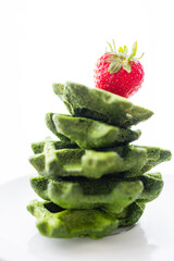 Stack of Green Spinach Waffles with Fresh Strawberry on Top