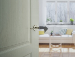 Door handle fitting on white door half opening through interior living room background, selective focus