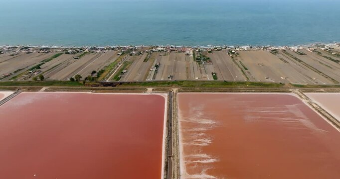 Aerial view of the Margherita di Savoia salt mines, in Puglia, Italy. They are the largest salt mines in Europe. In background is the Mediterranean Sea.
