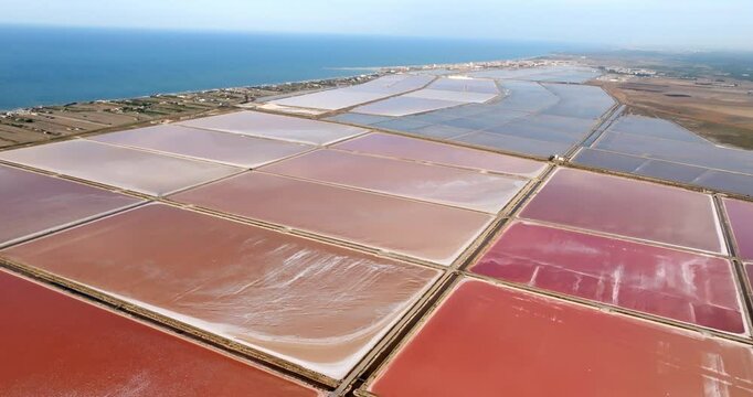 Aerial view of the Margherita di Savoia salt mines, in Puglia, Italy. They are the largest salt mines in Europe. In background is the Mediterranean Sea.