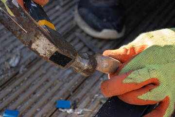 Carpenter works with wooden windows using a hammer and chisel. Preparing a wooden window frame. Installing windows. Carpenter's tools