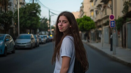 Fototapeta premium Woman with long hair is standing on a street