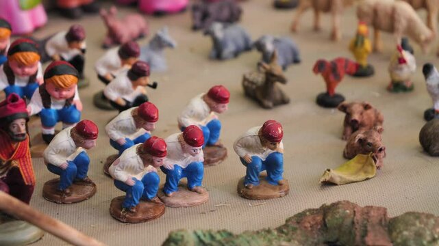 Fair on the square in Barcelona where there are many tents with figurines for the Nativity scene. Caganer is a traditional Catalan figurine for a nativity scene.