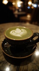 Fototapeta premium A close-up of a latte with intricate leaf art on a green beverage in a cozy caf? setting.