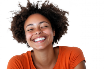 A joyful woman with curly hair beams with happiness while wearing an orange shirt. The bright expression captures a moment of pure delight, showcasing her enthusiasm and positive energy in a vibrant p